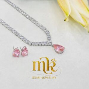 Silver-tone tennis necklace with pink drop pendant.