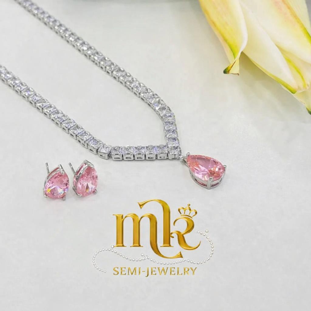 Silver-tone tennis necklace with pink drop pendant.